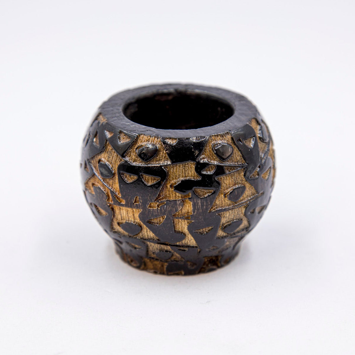 Decorative ceramic pot with intricate designs on a white background