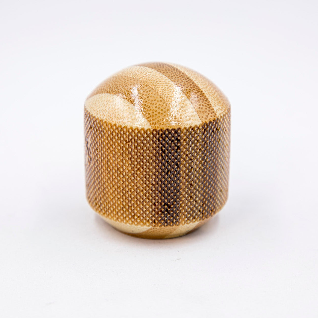 Gold textured cylindrical object on a white background