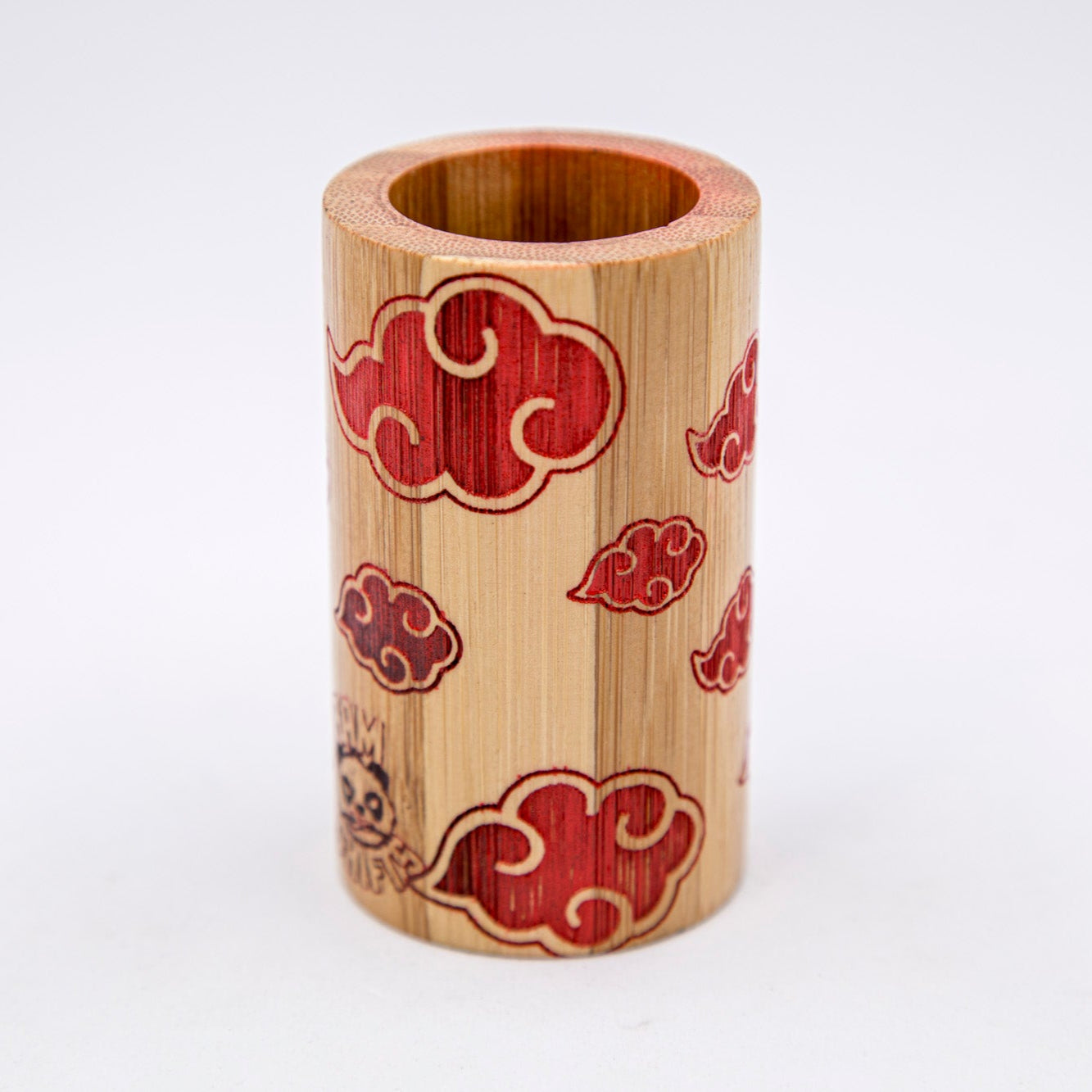 Wooden pen holder with red cloud patterns on a white background