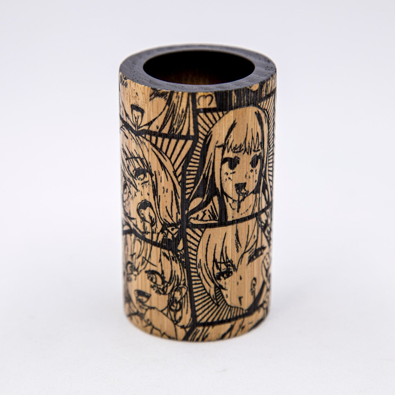 Wooden pen holder with engraved designs on a white background