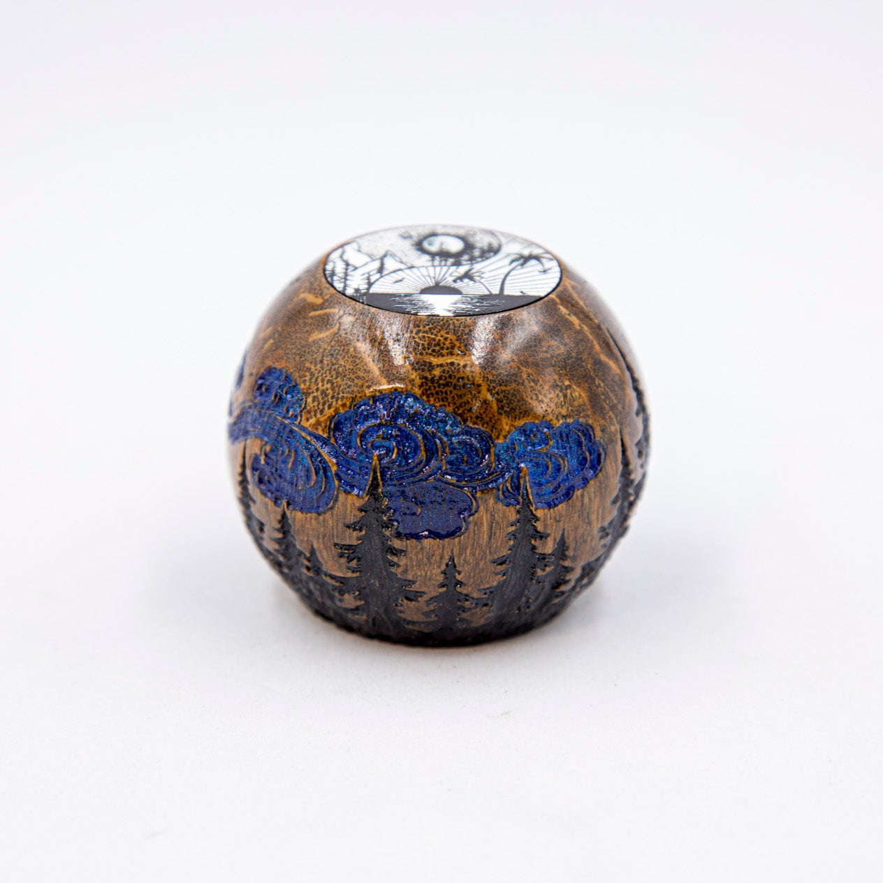 Decorative ceramic ball with blue floral patterns on a white background